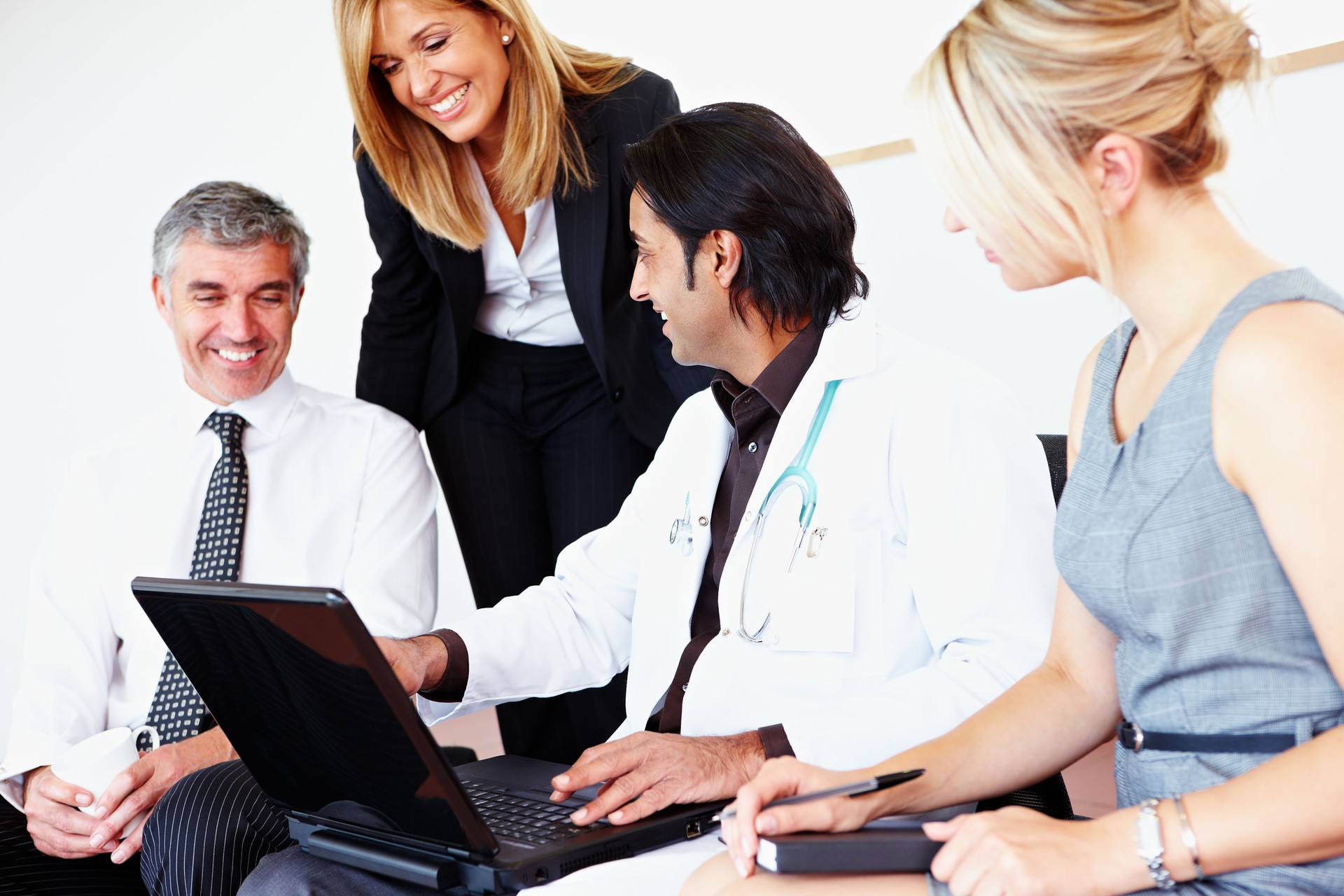 Doctor and business team working on laptop